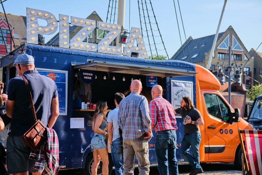 Pizza food truck serving customers.